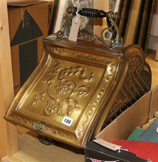 A Victorian embossed brass coal scuttle and implements